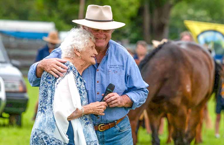 Life member Pam McLeod and Show Society President Ron Porter during the official opening of the Camden Haven Show. Photo: Kim Ambrose/SaltyFoxFotography.