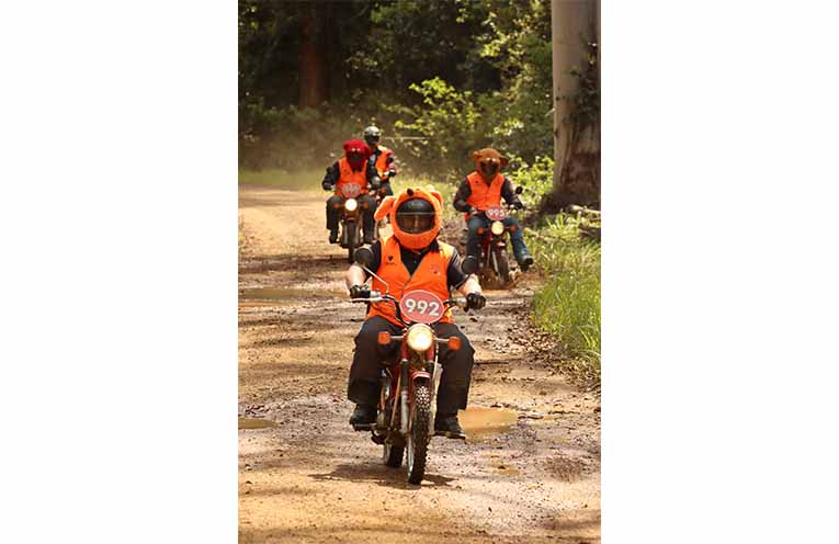 Posties riding on dirt roads for children in need. Photo: supplied.