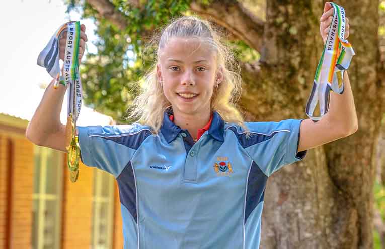 Scarlet Monk with her haul of medals from the School Sport Australia (SAA) Track and Field Championships. Photo: Kim Ambrose/SaltyFoxFotography.