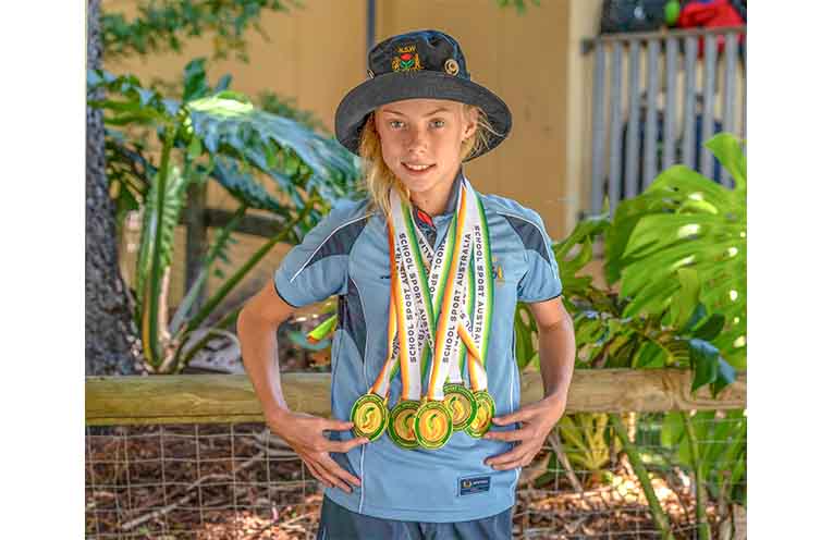 Scarlet Monk with her haul of medals from the School Sport Australia (SAA) Track and Field Championships. Photo: Kim Ambrose/SaltyFoxFotography.