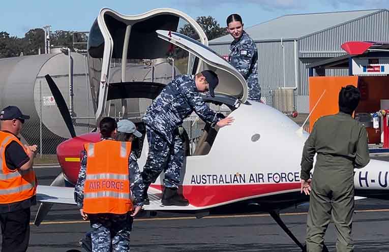 Liam Higgins climbs into an AAF training plane for a pilot experience flight. Photo: Sis Higgins.