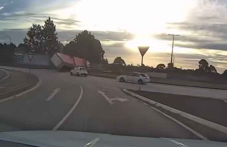 Dashcam shows the moment the B-double’s rear wheels lifted off the pavement. Photo: supplied to @PortMacquarieOnScene.