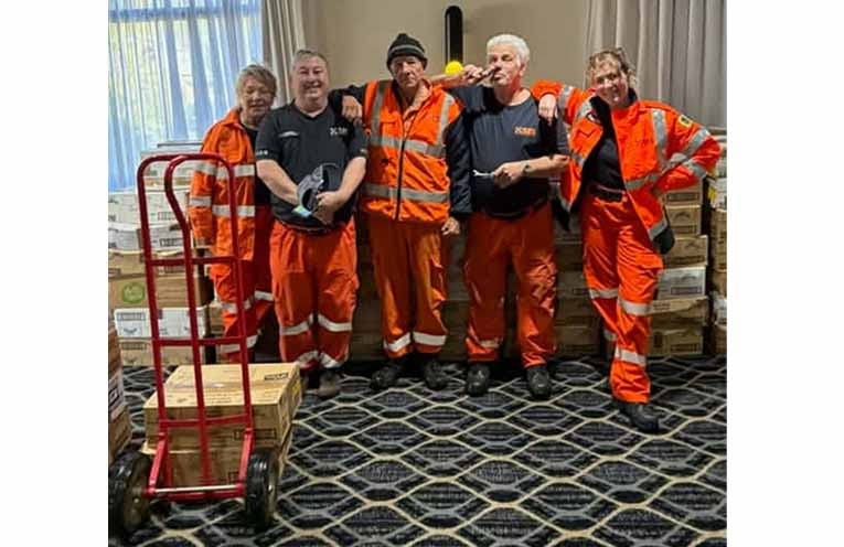 Camden Haven SES members lend a hand to move boxes of books. Photo: Rachael Thorpe.